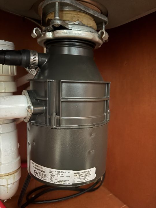 Garbage disposal installed under a kitchen sink