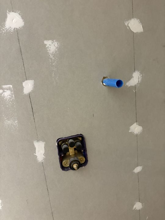 Shower valve rough-in installed on cement backer board